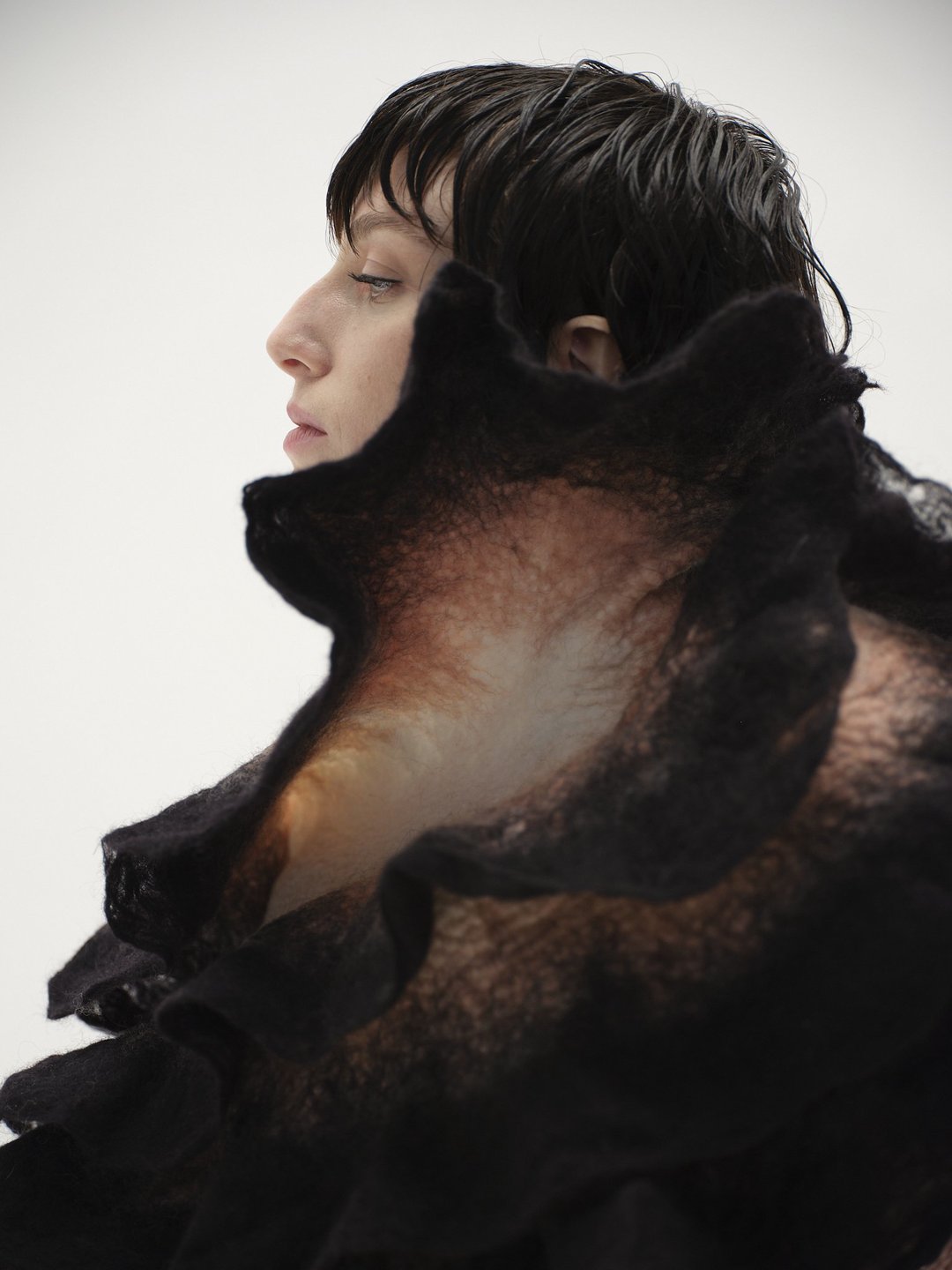 Flower Sculpture Scarf, a black felted collar, in side profile