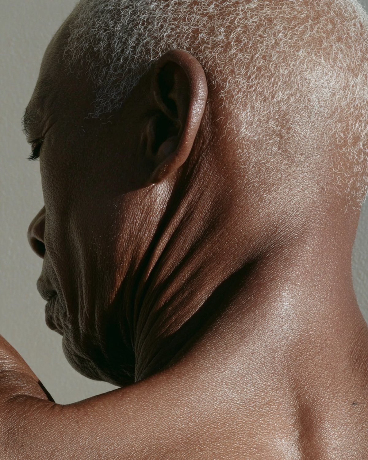Brand library, an older man's neck and shoulder in low side light