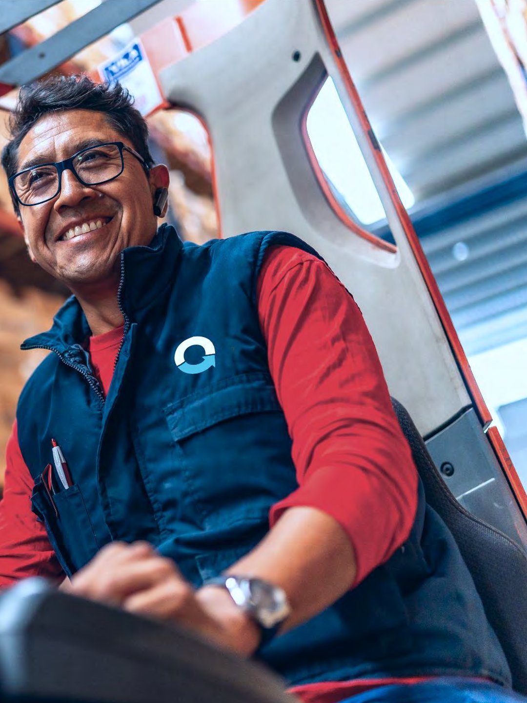 Brand guidelines application: a forklift driver in a navy vest carrying the OnLogistics symbol