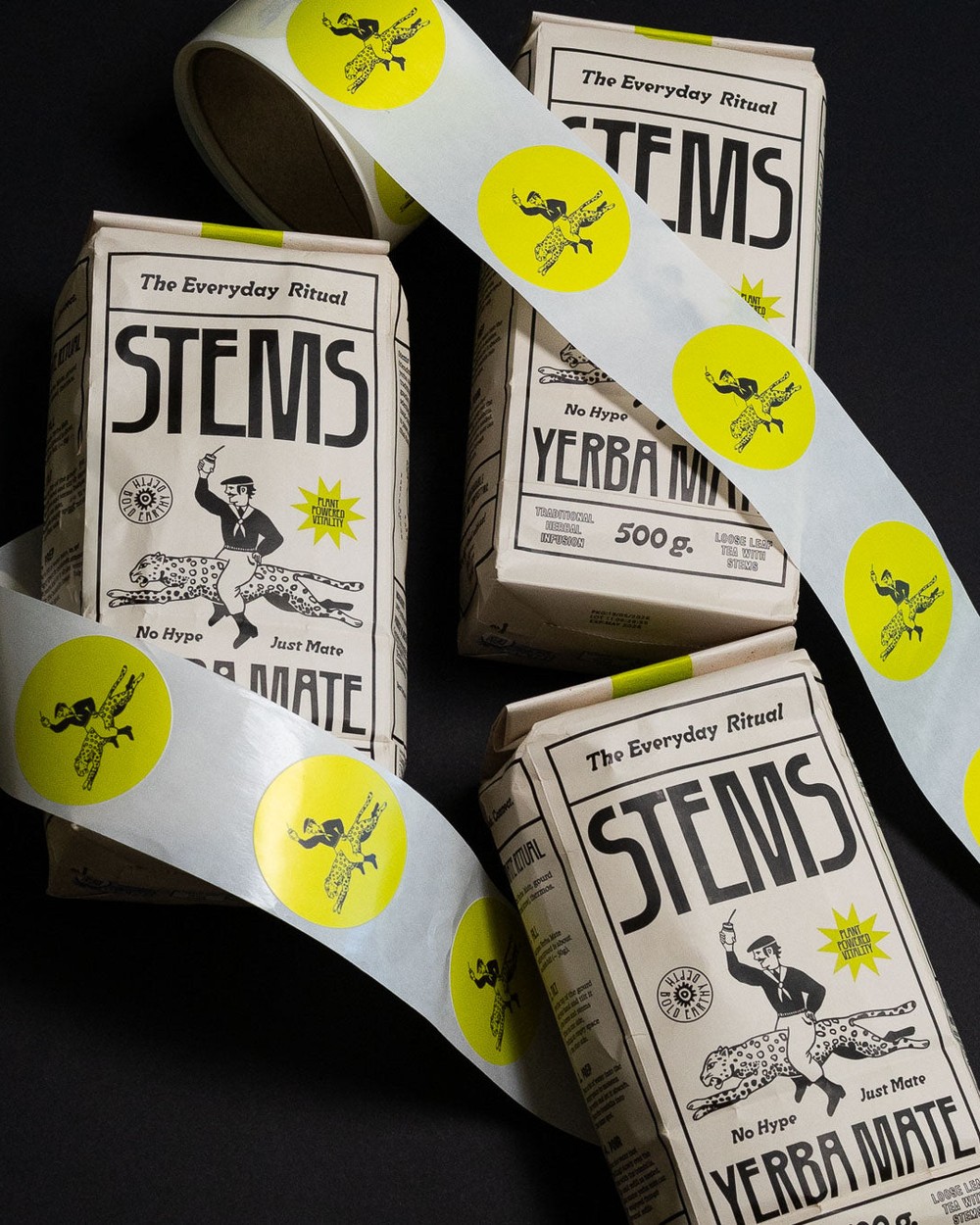Stems cartons with branded packing tape on a dark surface