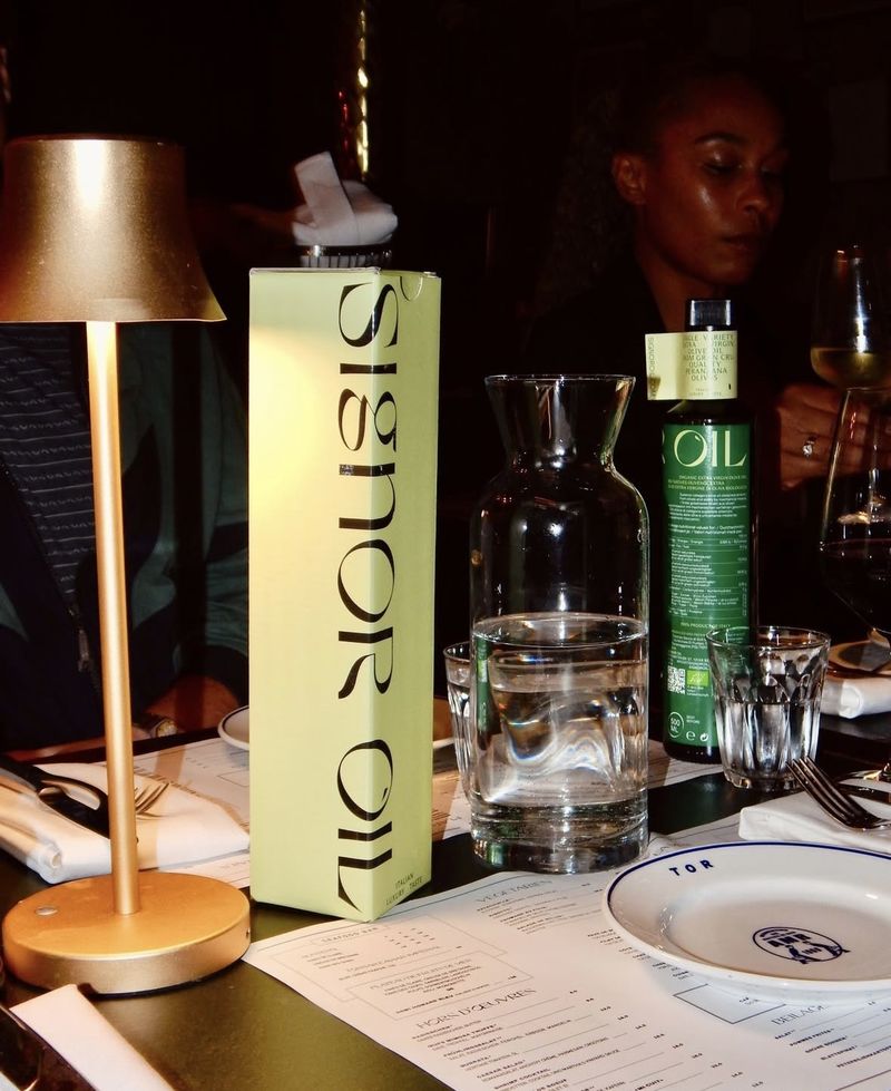 Signor Oil packaging by Ya Ting Yang: A sharp, quirky display serif runs the full height of a pale green olive oil box