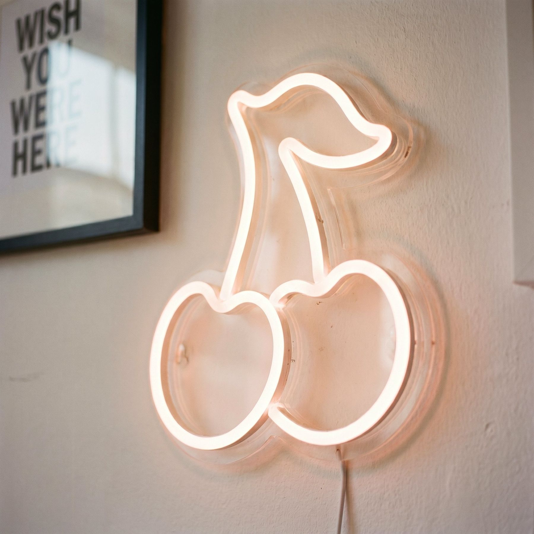 A cherry neon light on the studio wall