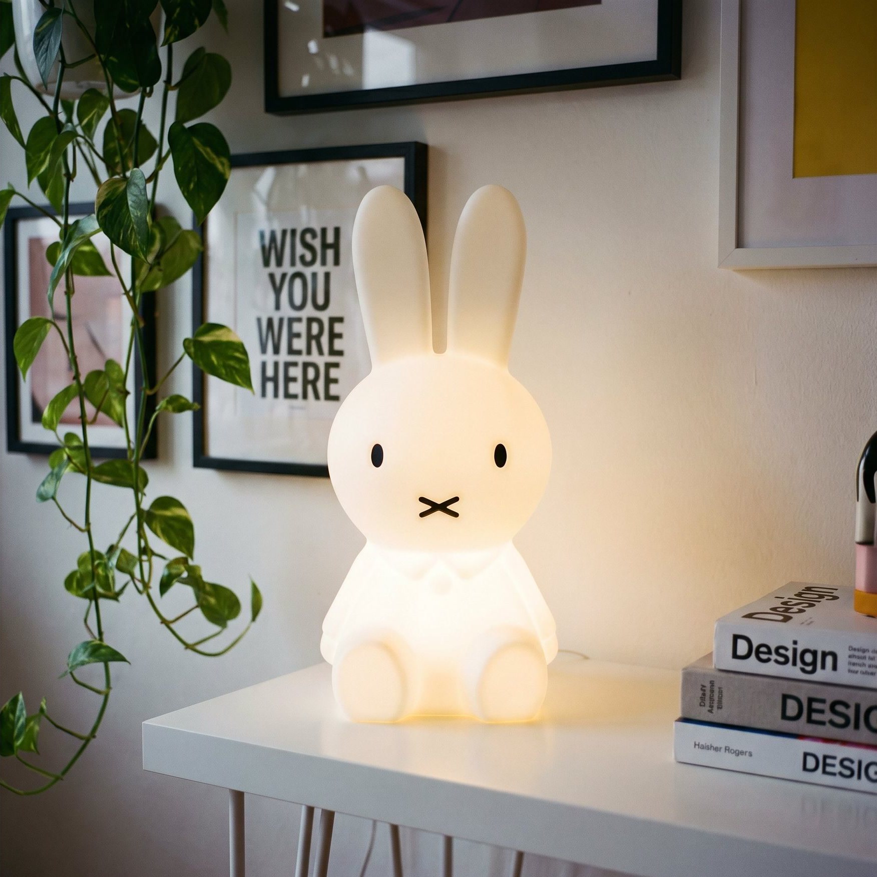 A lamp and design books on the studio desk