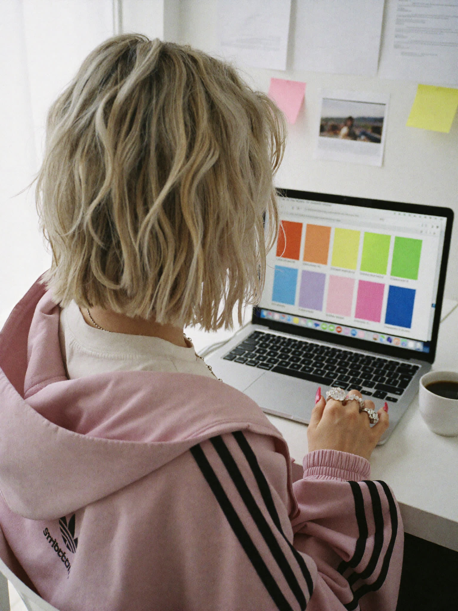 From behind: Sophie Evans at her laptop working on a colour palette