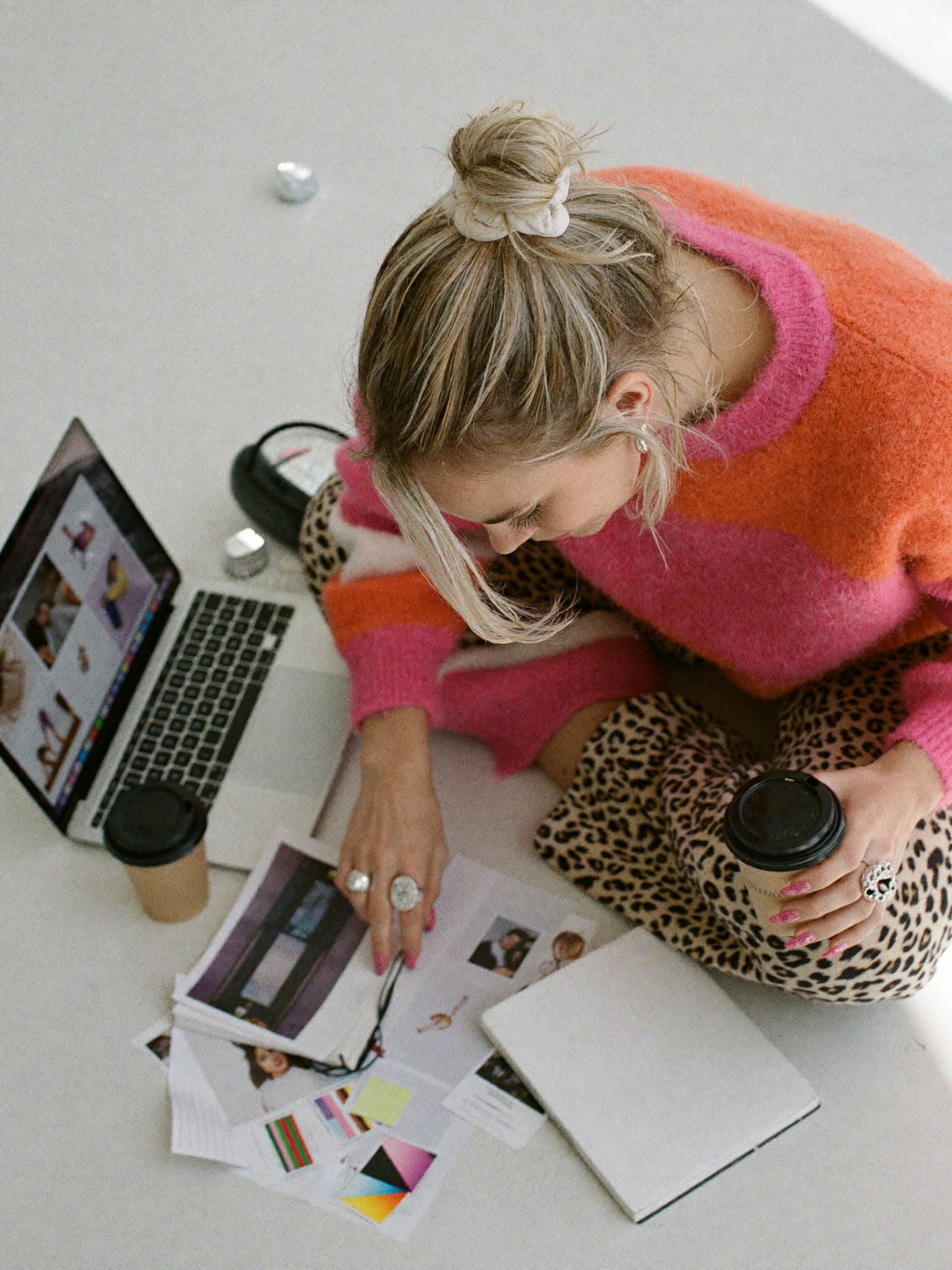 From above: Sophie Evans sorting printed images on the studio floor